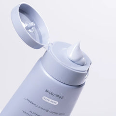 White skincare bottle with pump on a light gray background