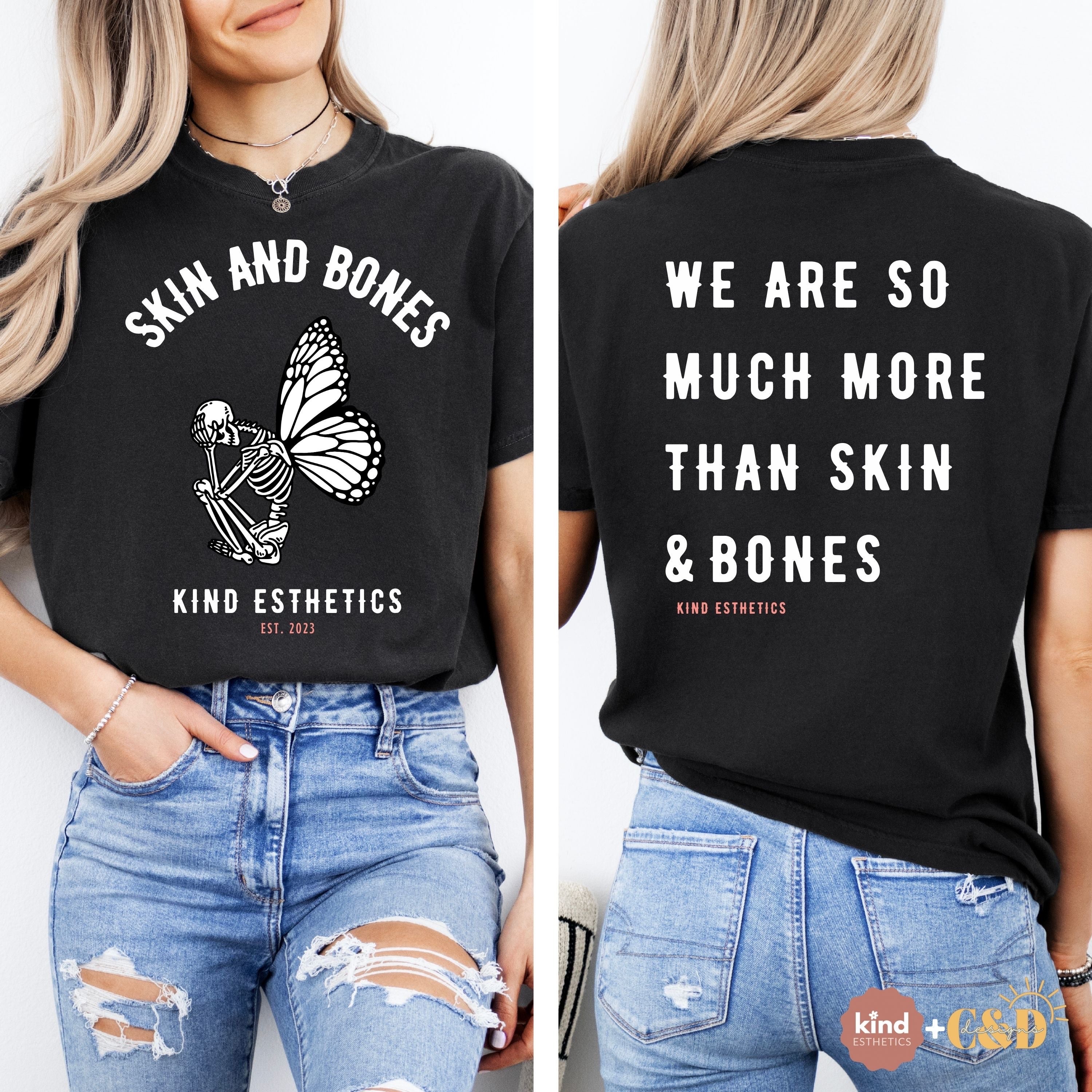 Black t-shirt with 'Skin and Bones' design and text on front and back, worn by a person.