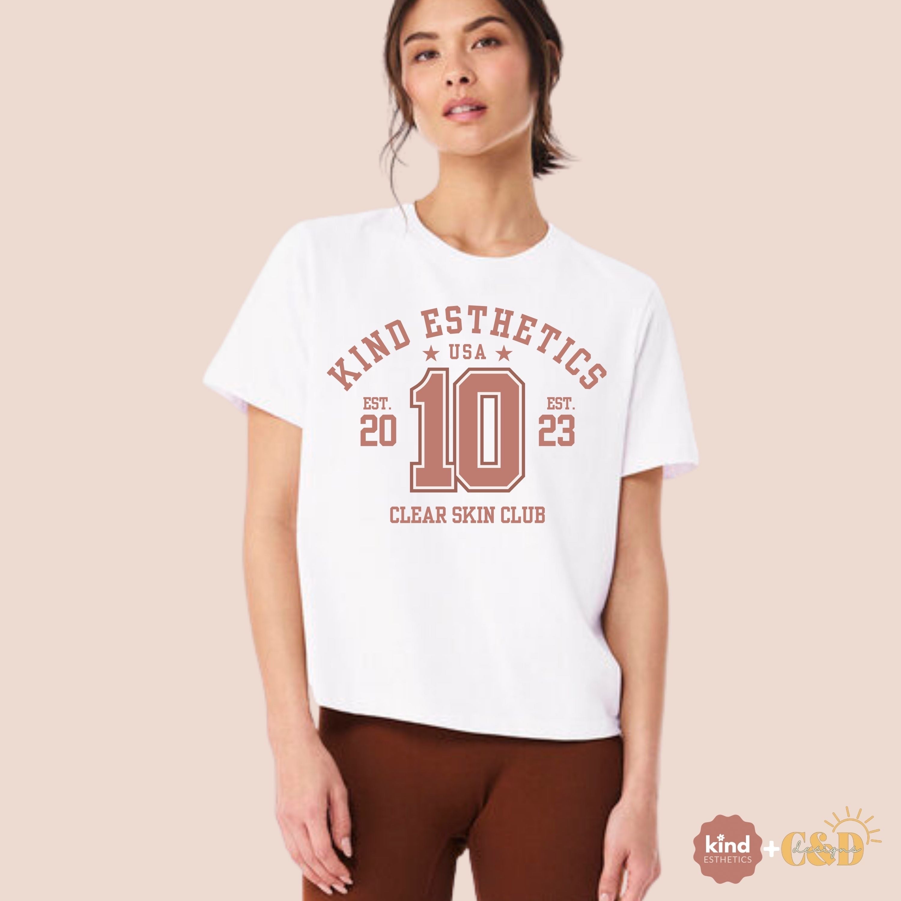 Woman wearing a white t-shirt with red text on a beige background