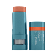 A stick of Sunforgettable Total Protection Color Balm SPF 50 with the cap off, showing the balm stick with a raspberry color shade.