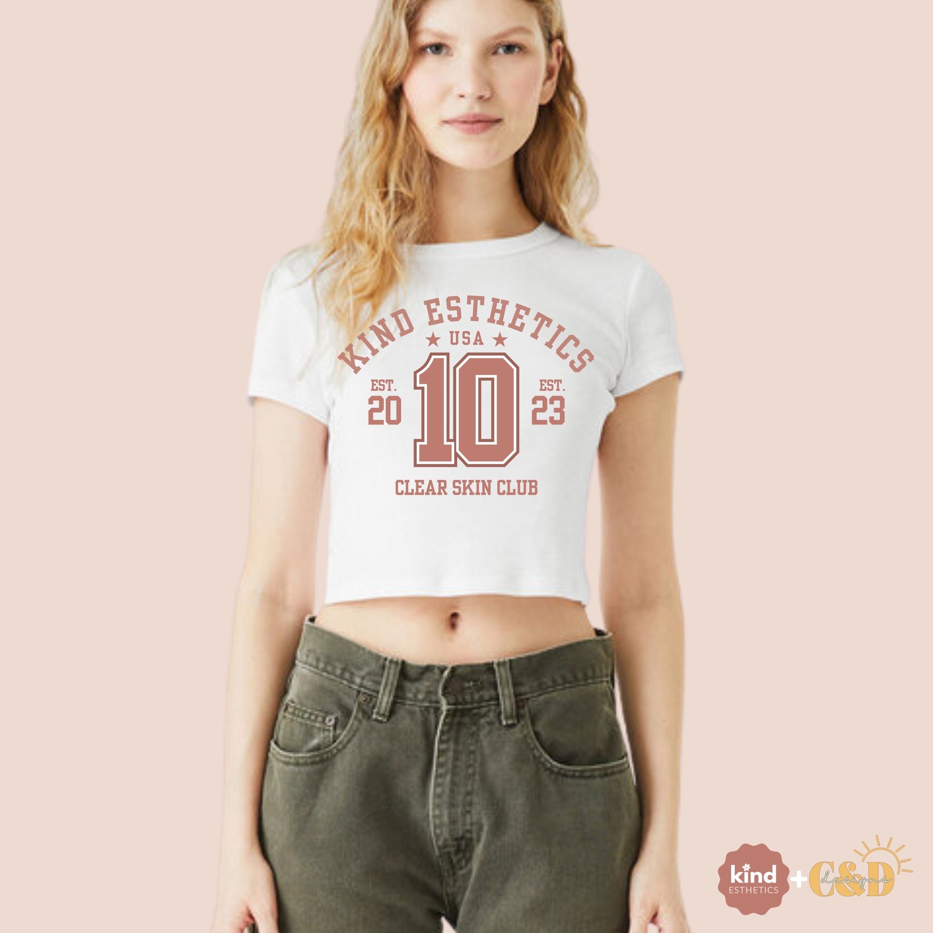 Woman wearing a white t-shirt with red text on a beige background